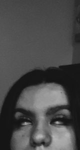 Black-and-white selfie of a woman rolling her eyes back dramatically