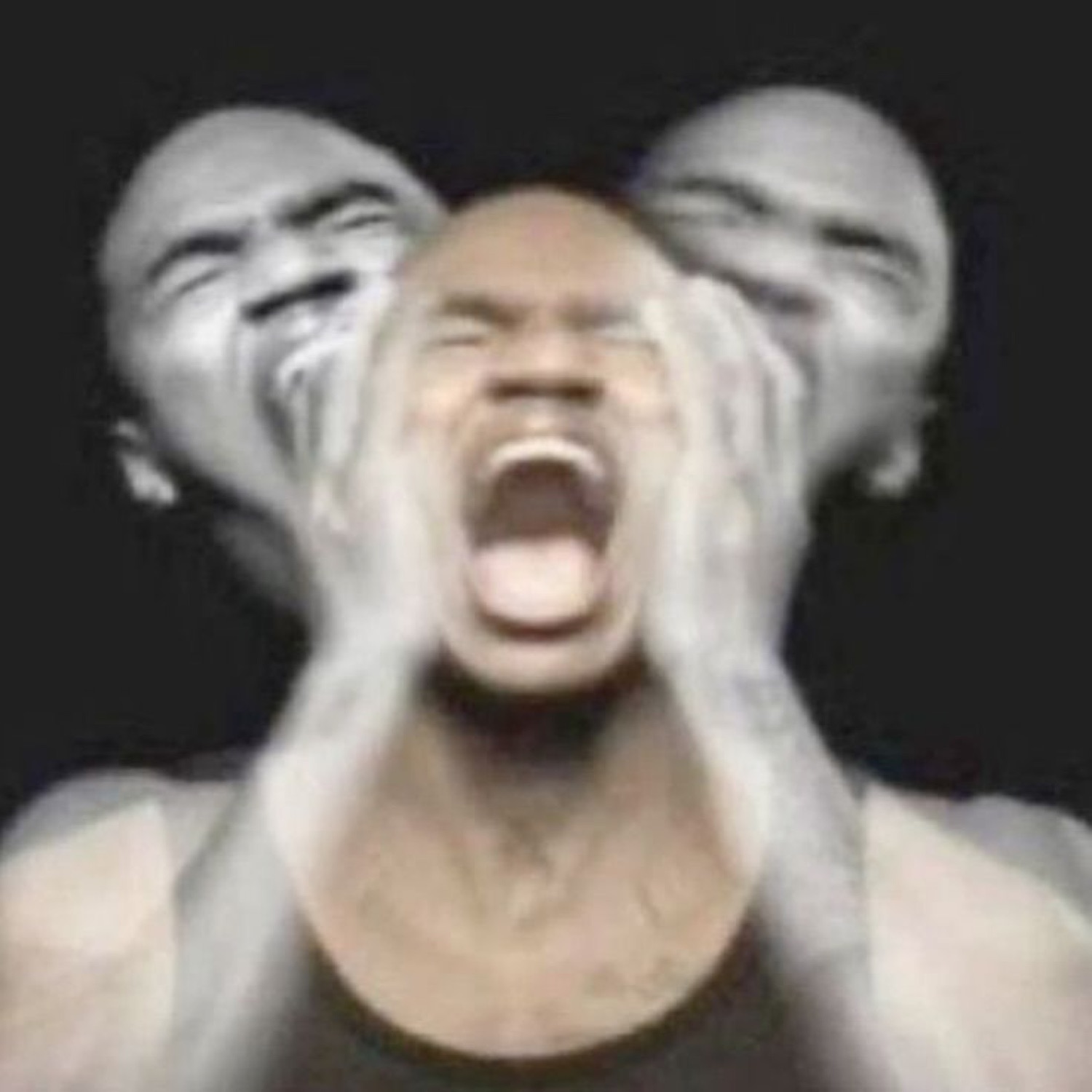 Man screaming with his hands on his head, face smeared into a motion-blur triple exposure
