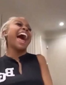 Woman with blonde hair laughing with her whole body, pure uncontrollable joy