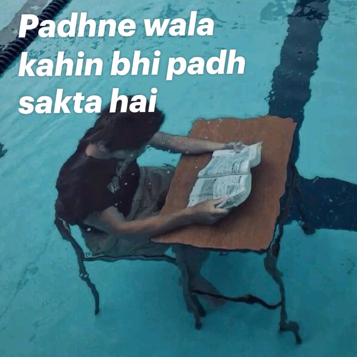 Man reading at a makeshift desk in a swimming pool: 'Padhne wala kahin bhi padh sakta hai' (one who wants to study can study anywhere)