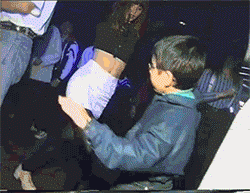 Kid in a denim jacket busting dance moves at a party