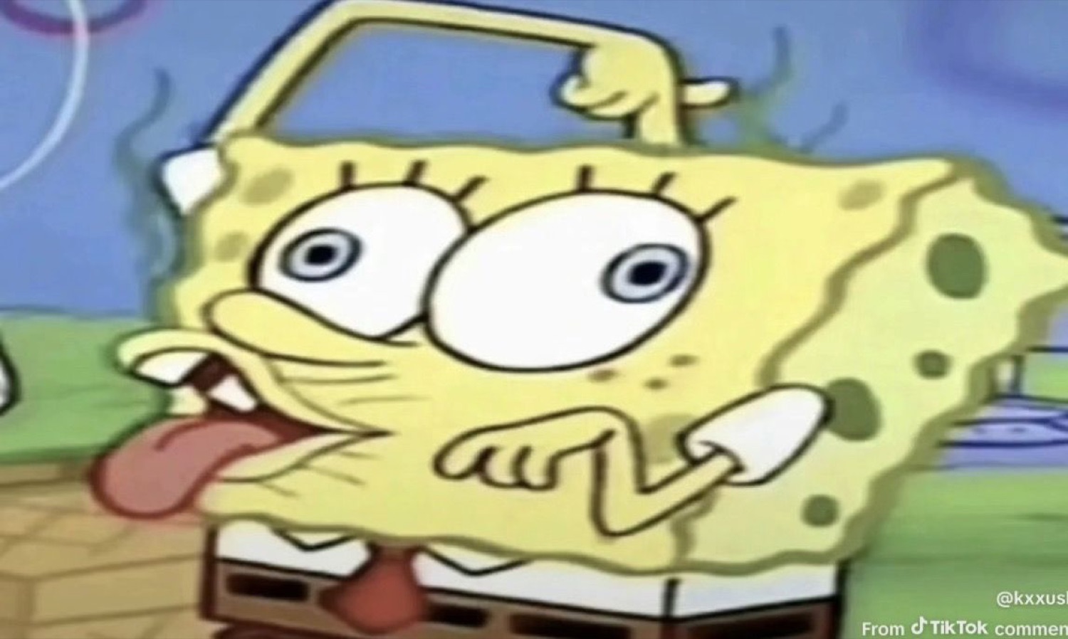 Wide-eyed SpongeBob with his tongue sticking out and squished face