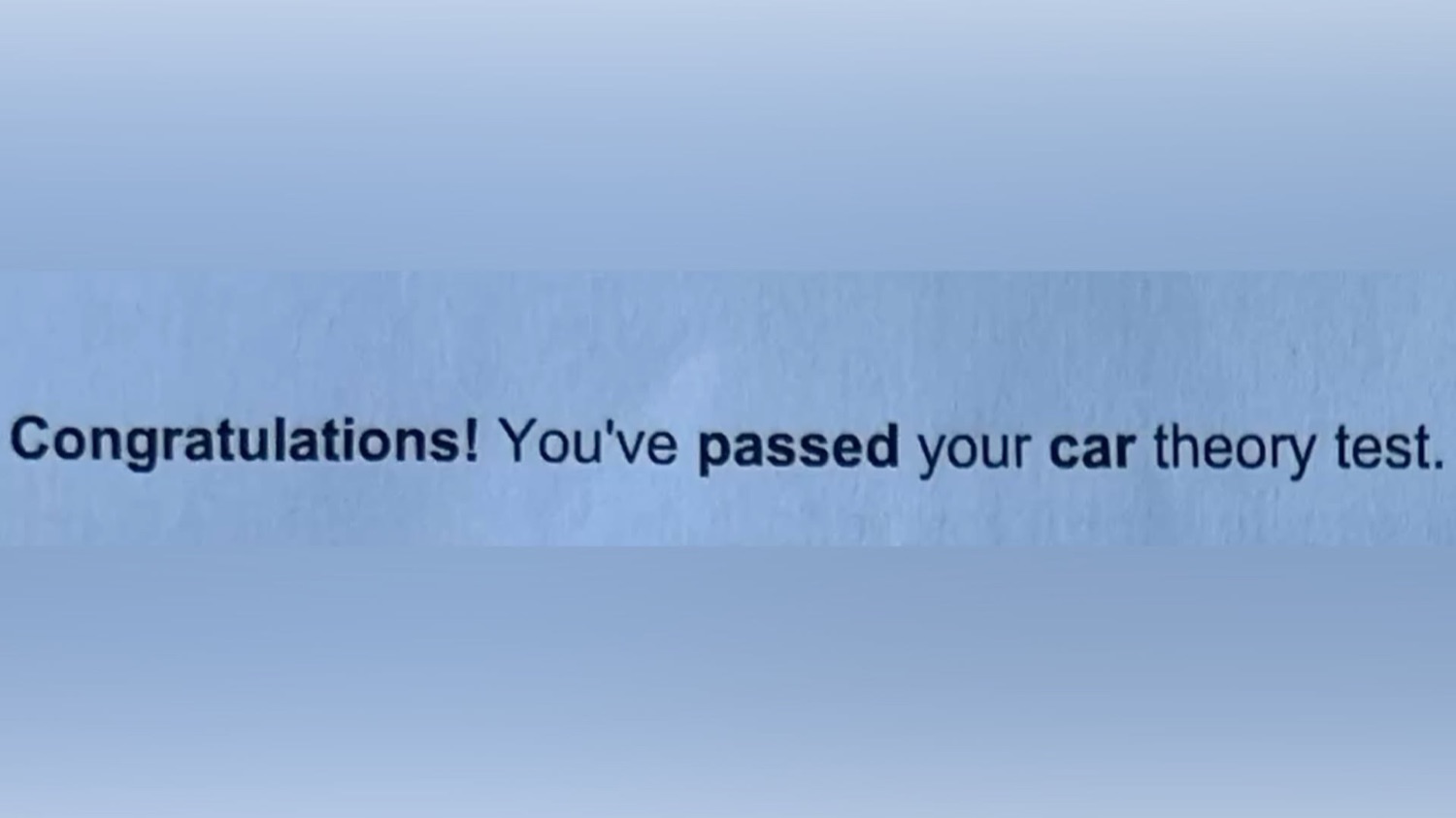 Screen text: 'Congratulations! You've passed your car theory test.'