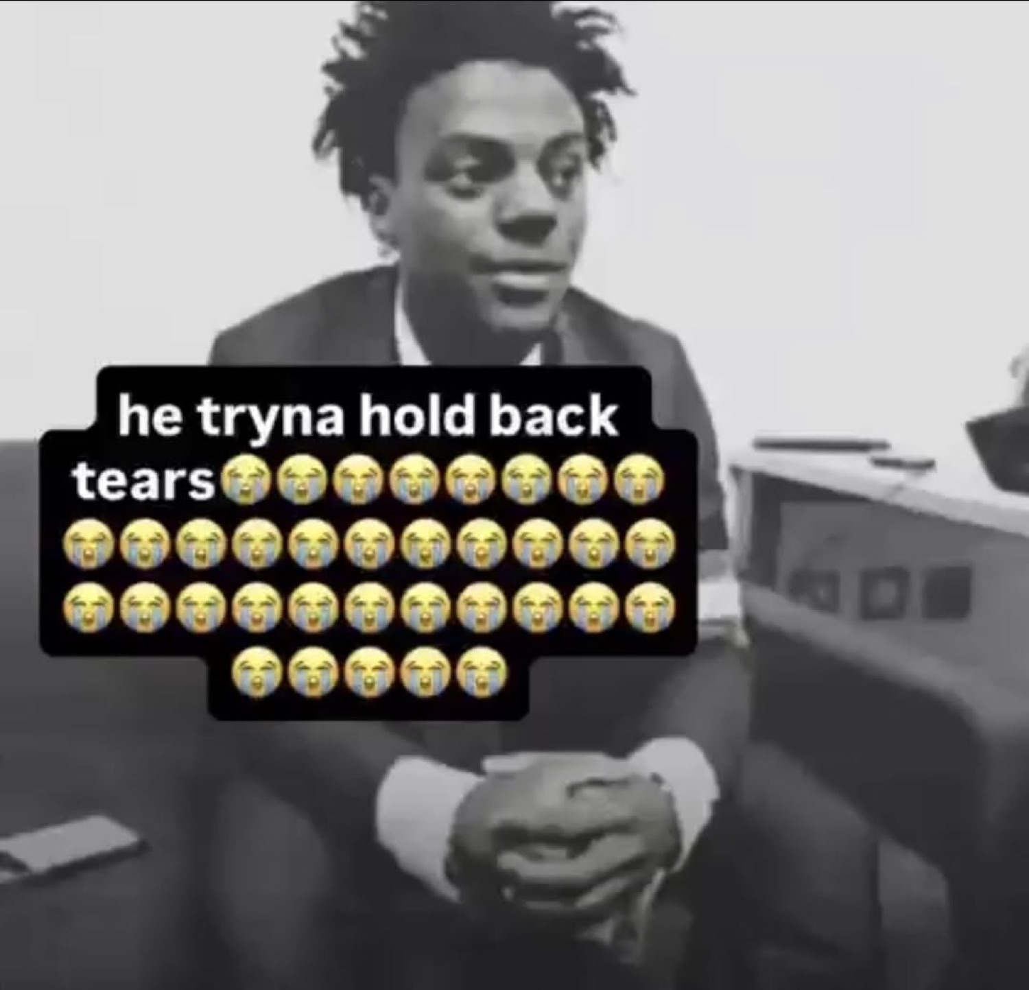 IShowSpeed sitting in a suit, captioned 'he tryna hold back tears'