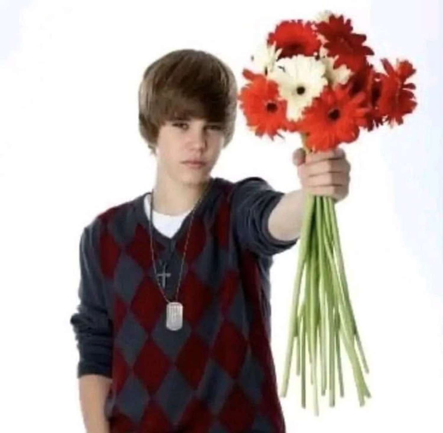 Young Justin Bieber deadpan in an argyle sweater, thrusting out a bunch of flowers