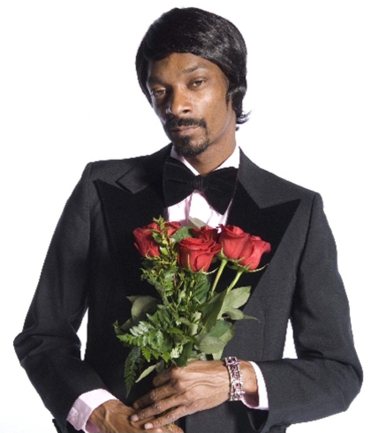 Snoop Dogg in a tuxedo holding a bouquet of red roses with a smooth confident look