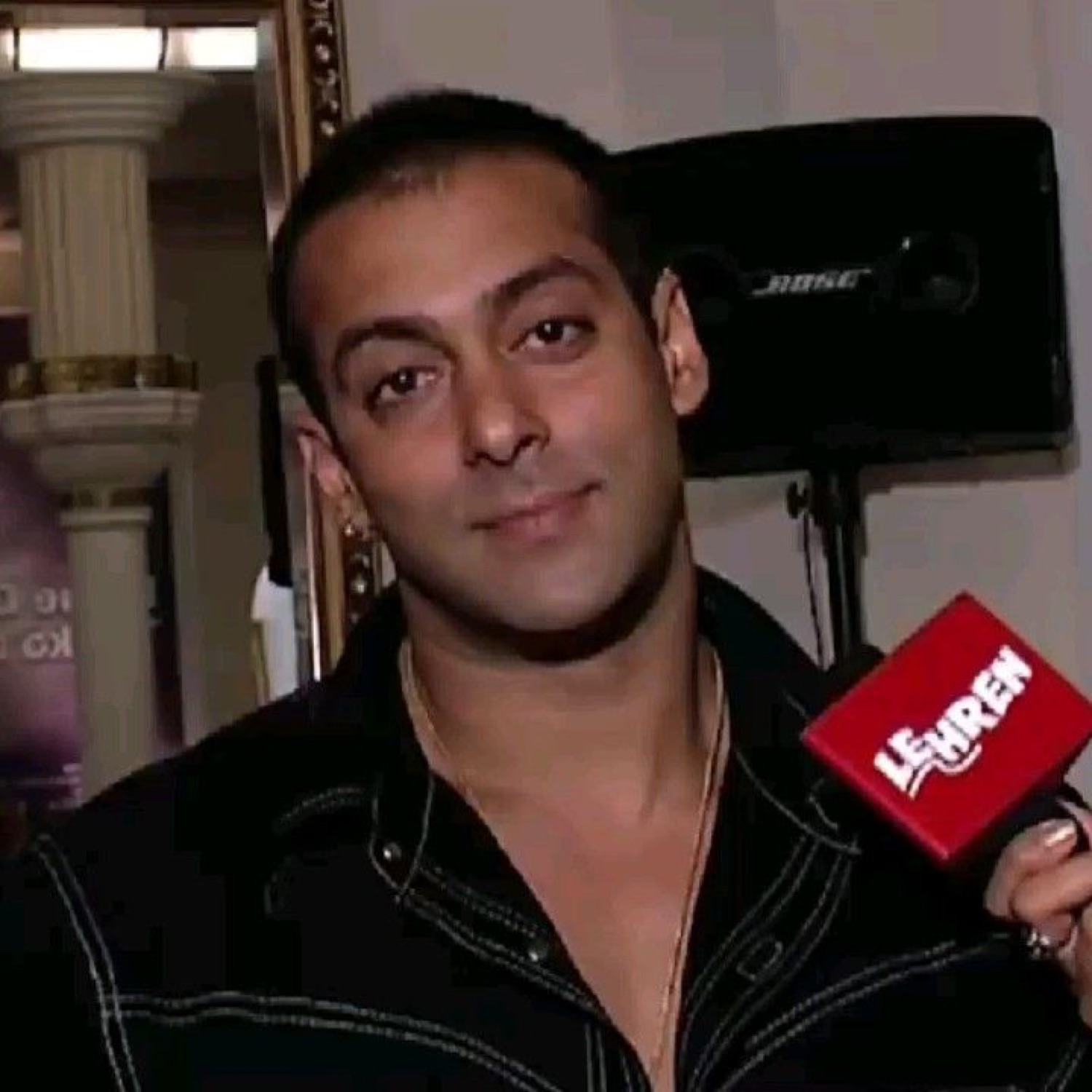 Salman Khan smirking at an interview microphone