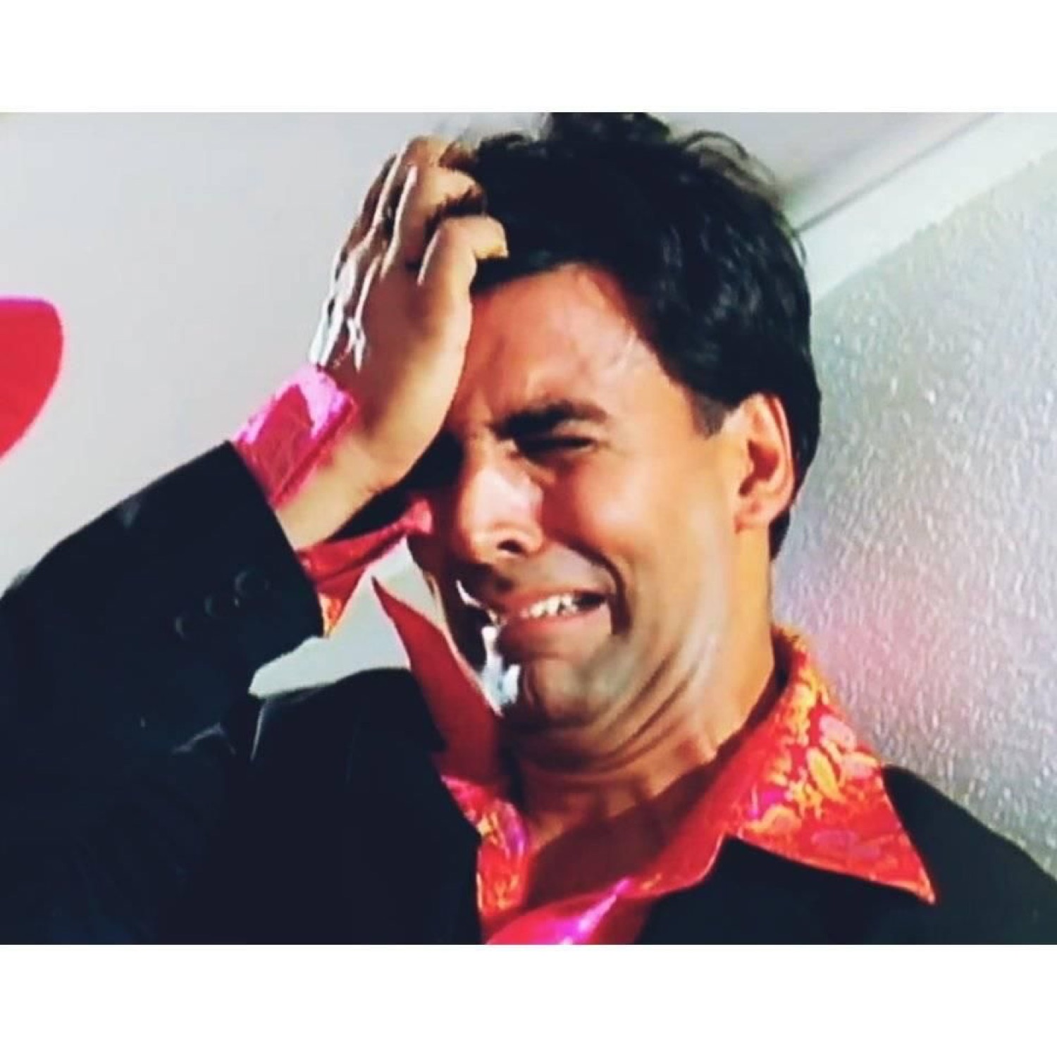 Akshay Kumar crying with a hand on his forehead