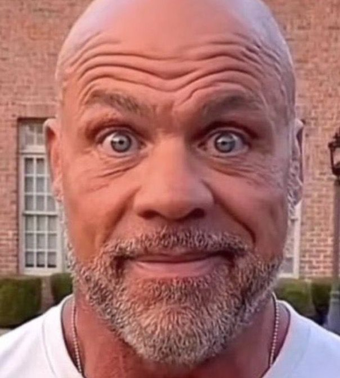 Bald older man with forehead wrinkles and bugged-out eyes staring in total disbelief