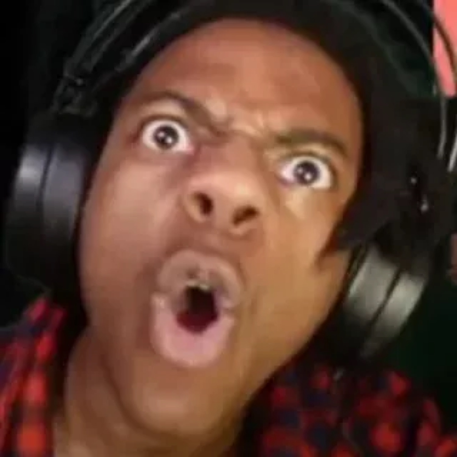 Streamer in headphones with bulging eyes and mouth wide open in total shock