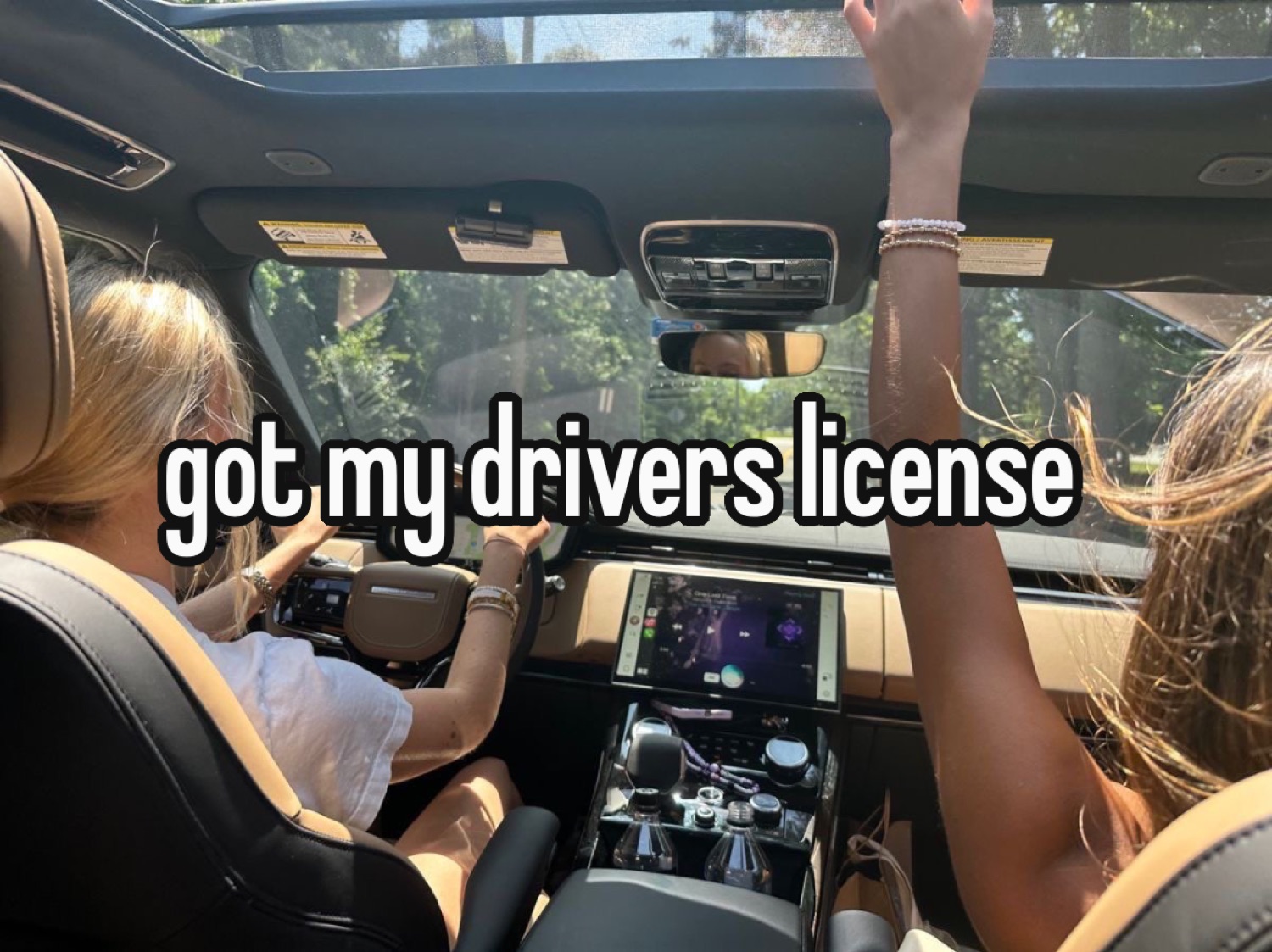 Friends cheering through a sunroof: 'got my drivers license'