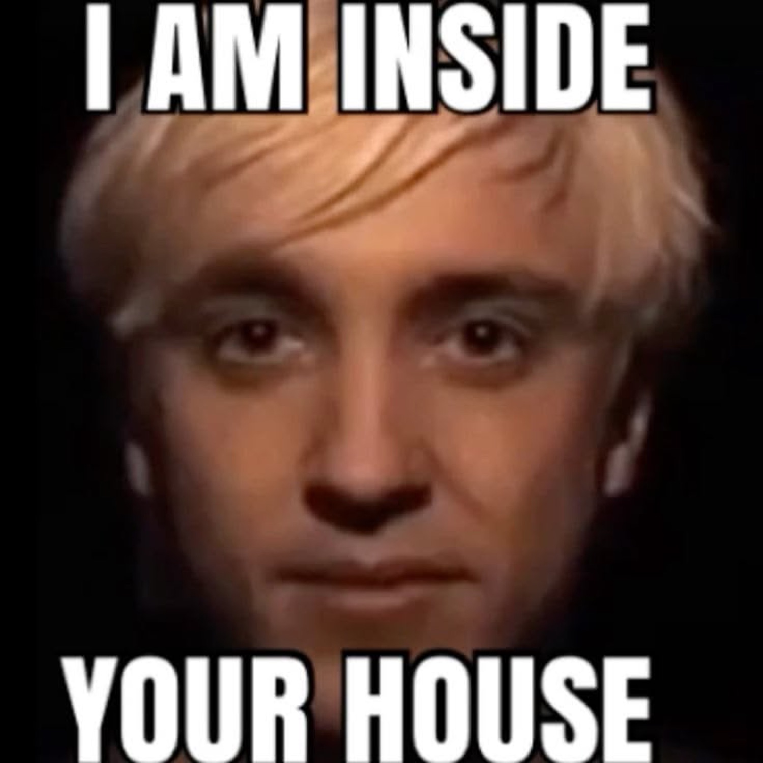 Close-up of Draco Malfoy staring intensely under 'I AM INSIDE YOUR HOUSE'