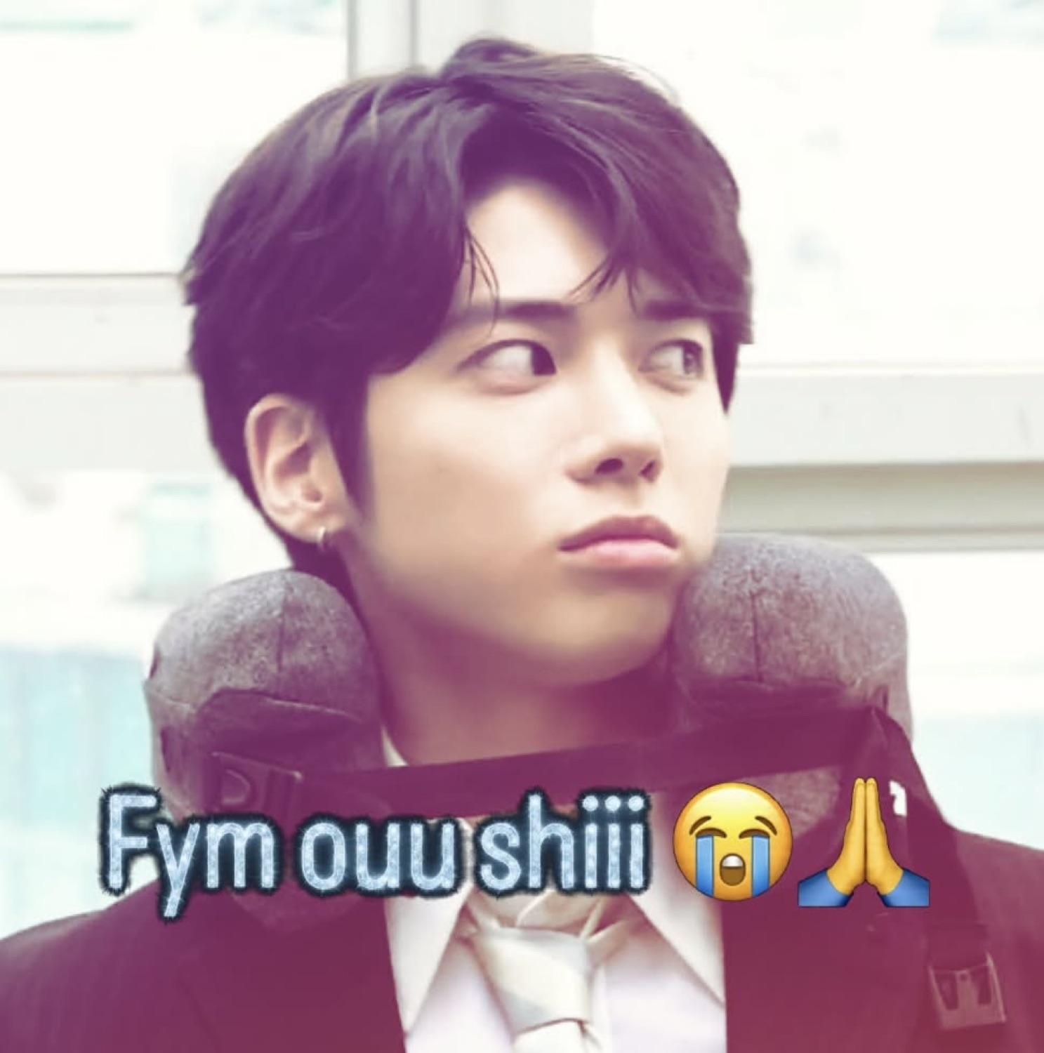 Idol in a neck pillow glancing off to the side, captioned 'Fym ouu shiii ๐ญ๐'