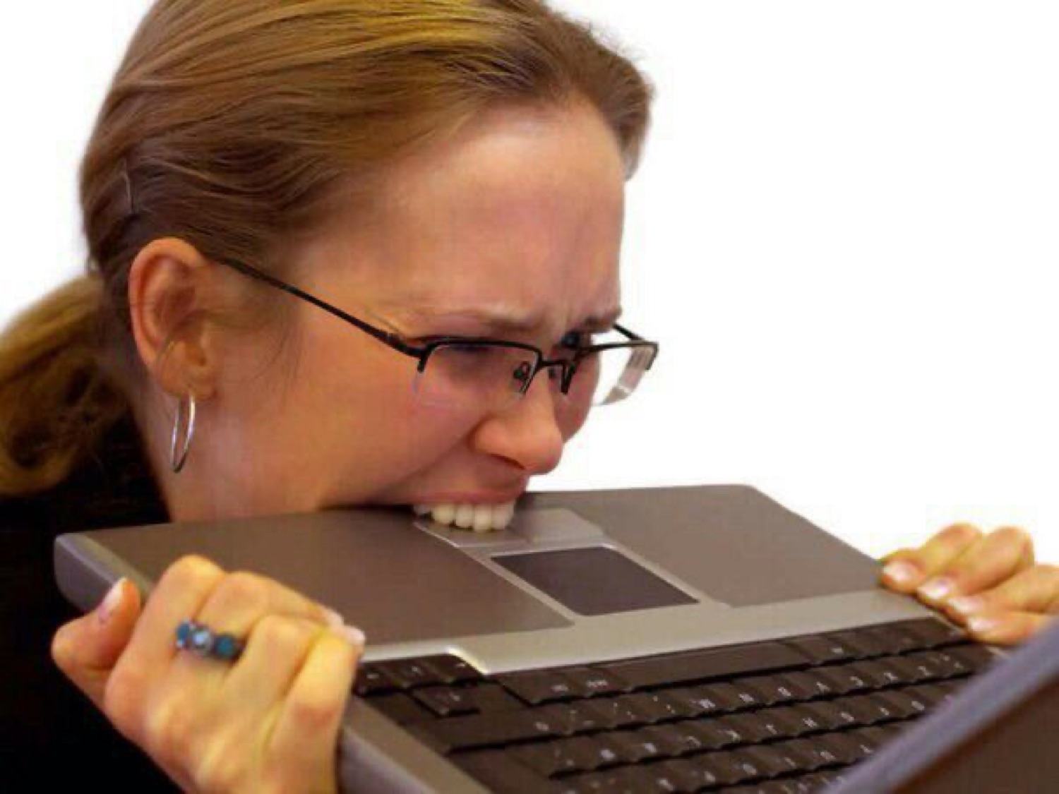 Woman in glasses biting her laptop in frustration