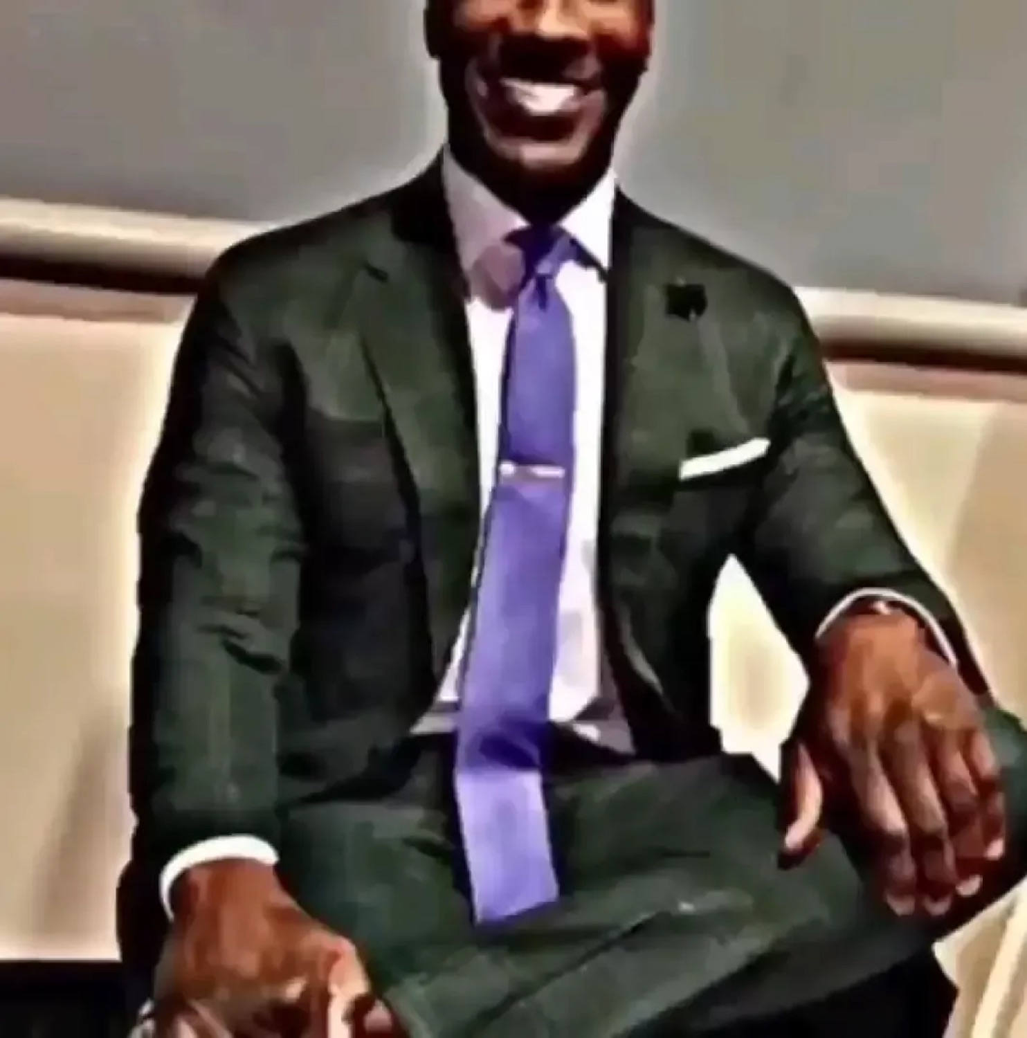 Smiling man in a sharp suit with a chiseled chad look