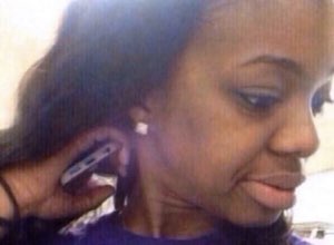 Girl with a phone wedged behind her ear looking completely unbothered