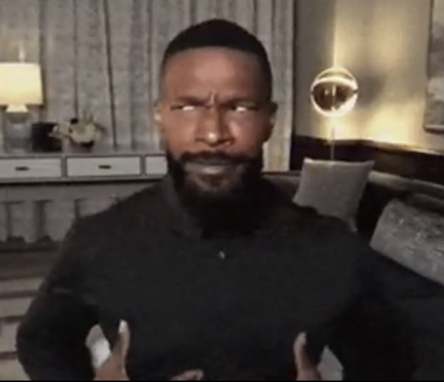 Jamie Foxx staring into the camera with a furrowed brow and arms slightly spread, deeply unamused