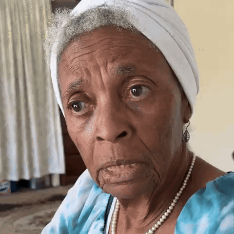 Elderly woman squinting and scrunching her face in confusion