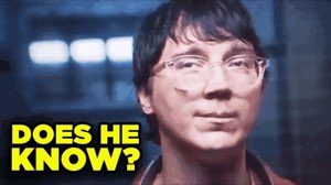 Guy with glasses giving a knowing sidelong glance, captioned 'DOES HE KNOW?'