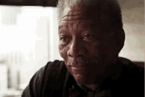 Morgan Freeman smiling softly and saying "Good luck"