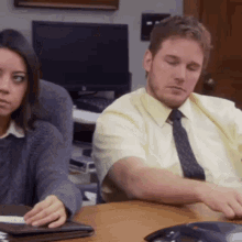 Office worker slumped in a chair with his head rolling back from boredom