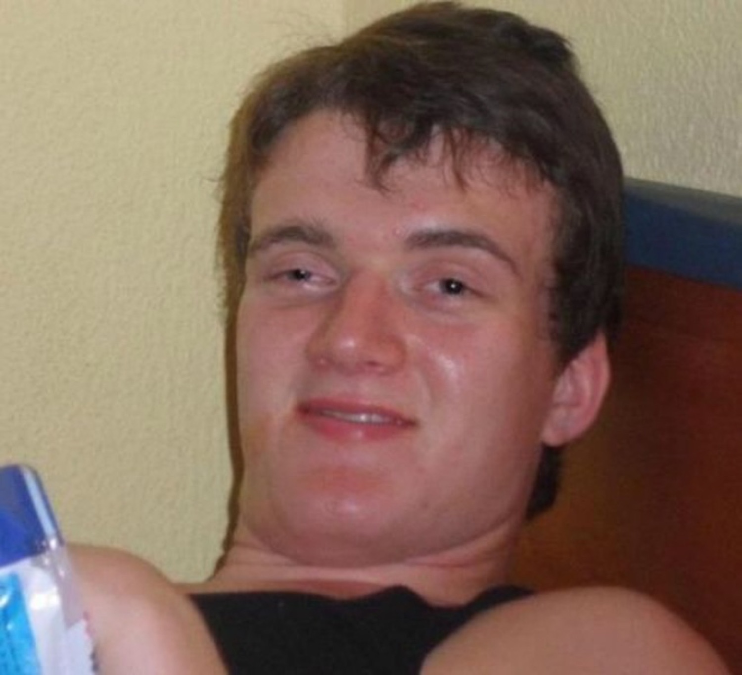 Slouchy guy reclining with a glazed, half-lidded smirk, completely unbothered