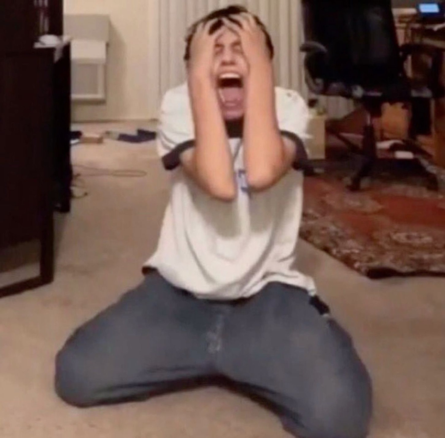 Guy on his knees screaming and clutching his head