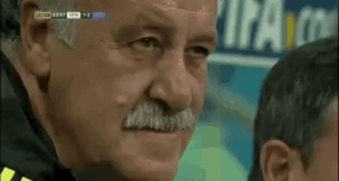 Older man with a mustache wincing in pain