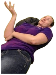 Woman lying on a couch mid-gesture like a therapy session while a fluffy cat sits on a chair with a clipboard sticker