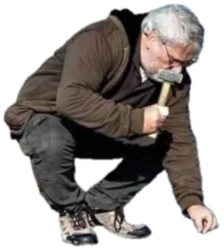 Man crouched at the shoreline hammering nails into the wet sand as the tide comes in sticker