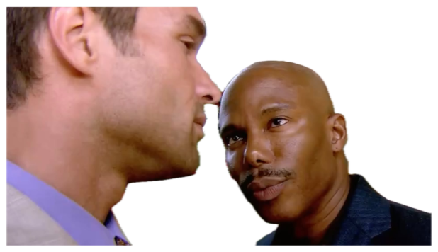 Two men staring each other down in tense close-quarters face-off inside a decorated venue sticker