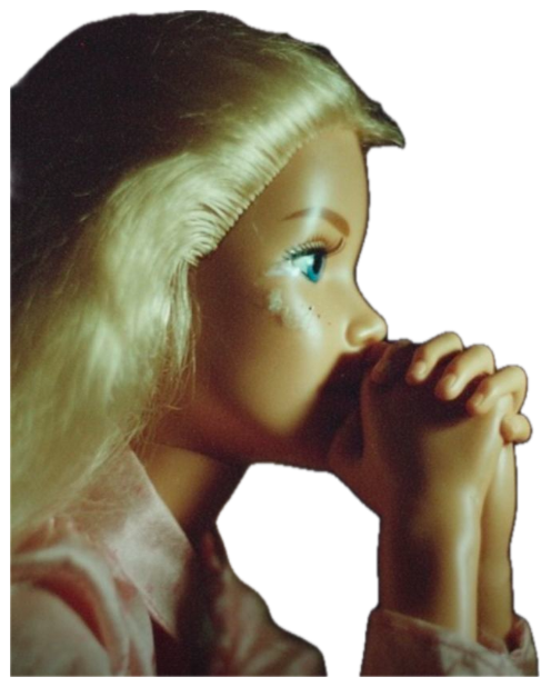 Doll with a human-like face resting on clasped hands in a pensive, prayerful pose sticker