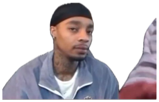 Guy in a durag sitting in a crowd with a flat, checked-out stare sticker
