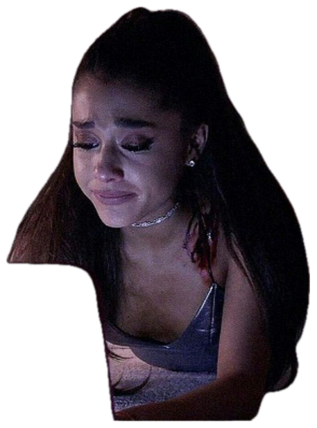 Young woman with a high ponytail crying at a laptop in a dim room as a red devil figure looms behind sticker
