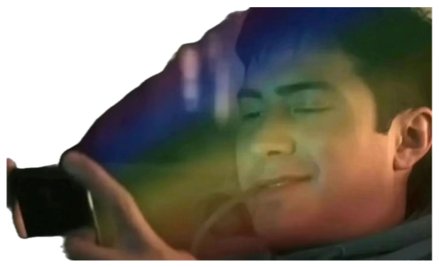 A man smiling softly with eyes closed at his phone, bathed in a rainbow glare sticker