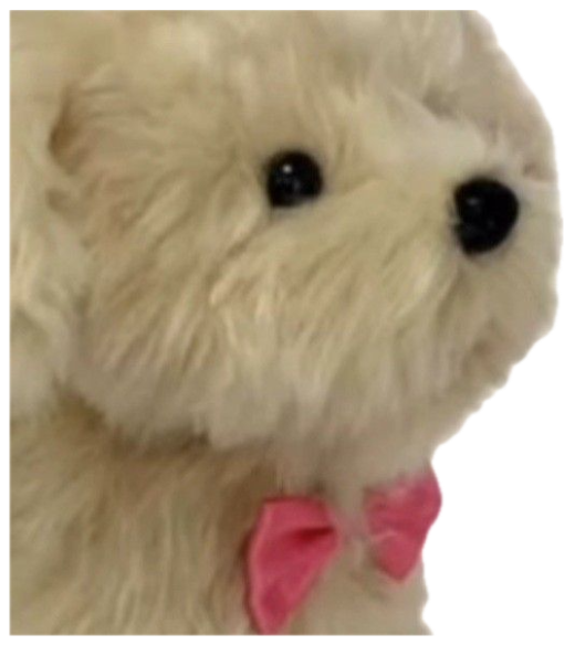 Fluffy white toy dog with a pink bow staring sideways, captioned 'aja' sticker