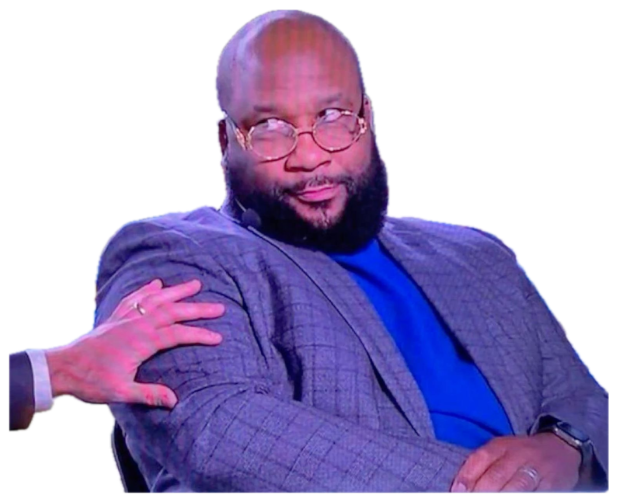 Bearded analyst in a stadium cutting a slow side-eye at whoever grabbed his shoulder sticker