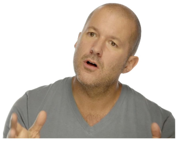 Bald man in a grey tee mid-sentence, gesturing with both hands as he earnestly explains sticker